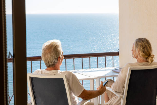 istock Mature couple relax on balcony above sea 2071284597