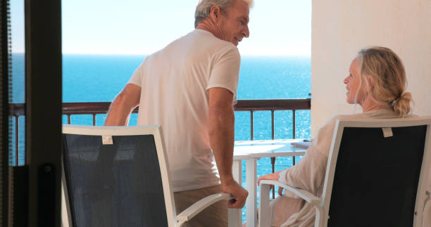 istock Mature couple relax on balcony above sea 2071284599