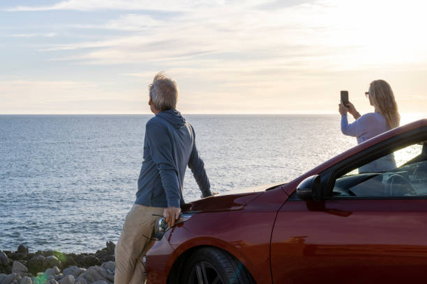 istock Mature couple pause by sea with vehicle 2071293982