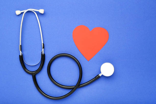 istock Stethoscope with red paper heart on blue background 2071295522