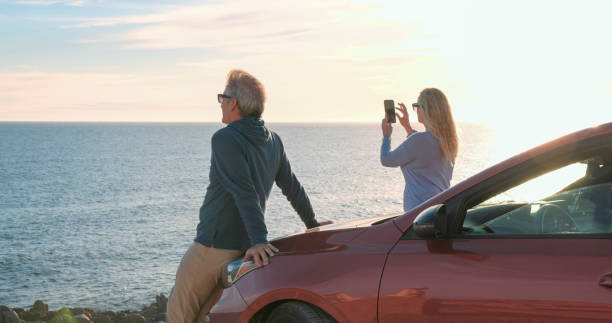 istock Mature couple pause by sea with vehicle 2071296028