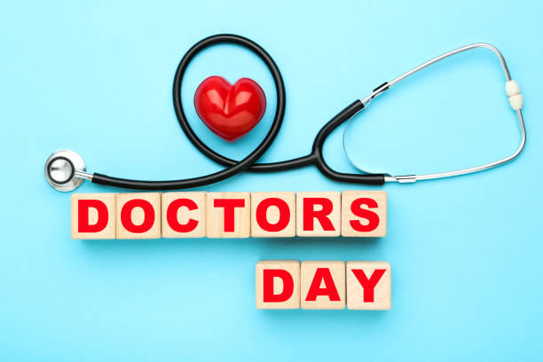 istock Stethoscope with red heart and text Doctor's Day on blue background 2071299655