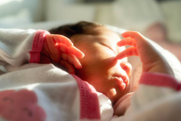 Newborn baby boy, just two weeks old,  lying on his mother hand