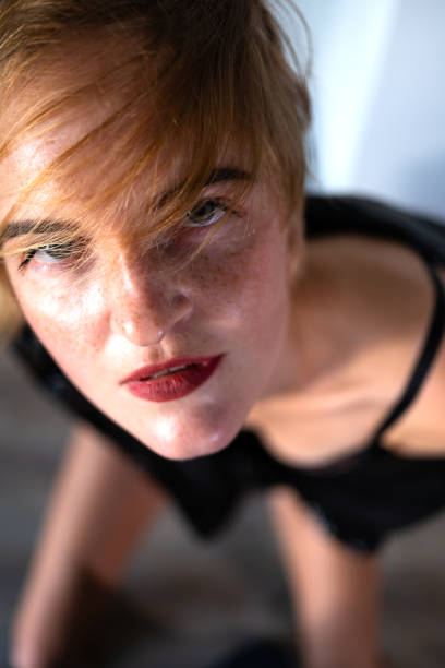 Portrait of a beautiful young blonde woman with red lipstick and intense gaze