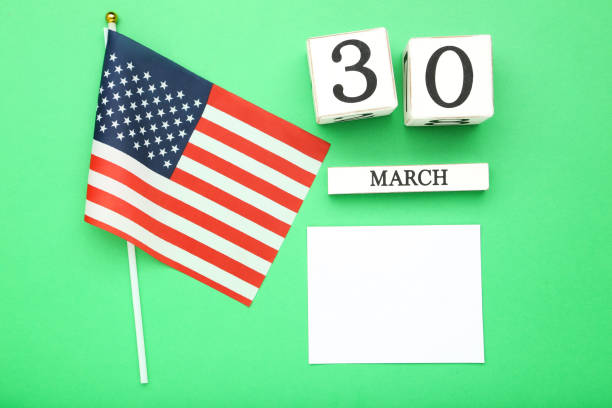 istock Text Doctor's Day with cube calendar and american flag on green background 2071319226