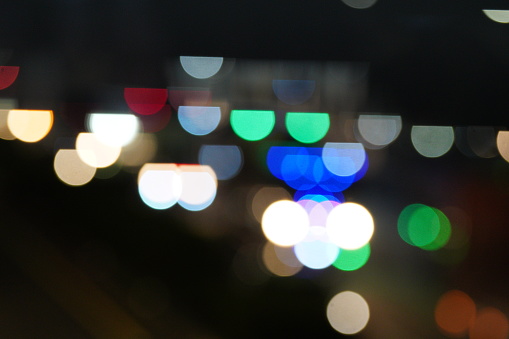 Bokeh abstract background of traffic jam in the city at night, headlights of cars selective focus