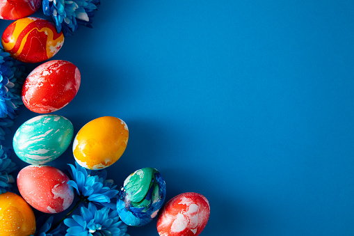 Painted easter eggs in a row on blue background