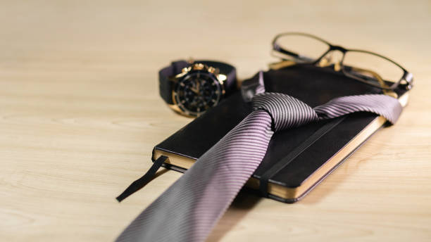 istock A banner with a clock, glasses, planner, and tie on a wooden surface. Father’s Day concept, celebration. Personal objects. copyspace 2071383890