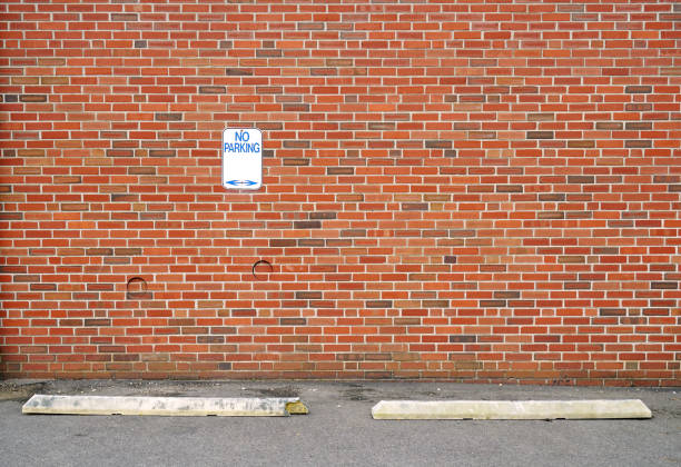 istock no parking sign on the brick wall in the parking space 2071384093