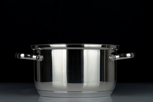 Stainless steel pan isolated on black background.