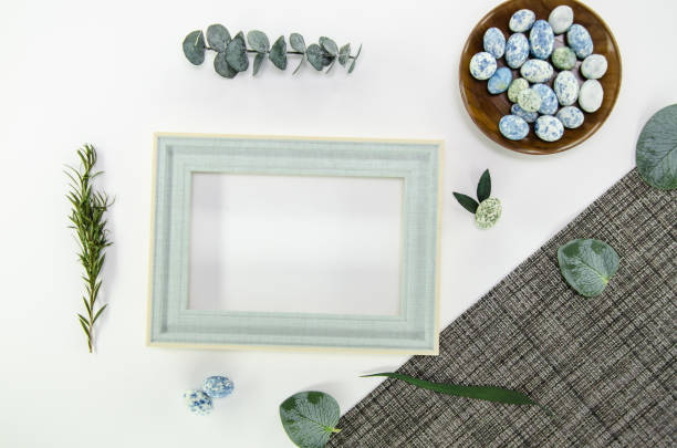 istock Blue easter eggs on white background with gray tablecloth with dried foliage and light blue wooden frame - easter composition with copy space, flatlay 2071401564