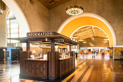 Los Angeles, CA - USA: Information booth at Union Station looking into Grand Hall with lighting and arches