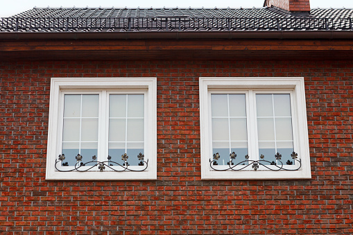 Two windows in a red brick house