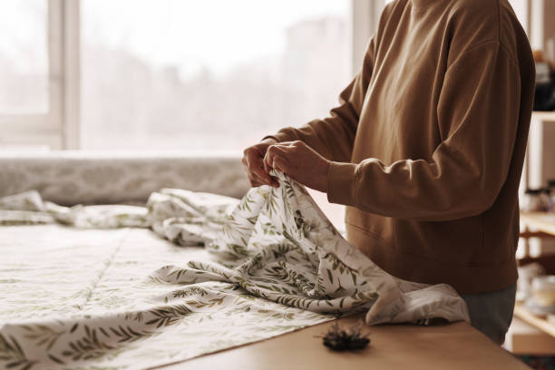 istock Craftswoman in sewing workshop preparing fabric for project 2071488225