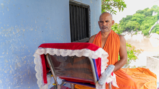 Religious Hindu monk meditating, wearing saffron, in Kahalgaon, Bihar, India - 07 10 2023