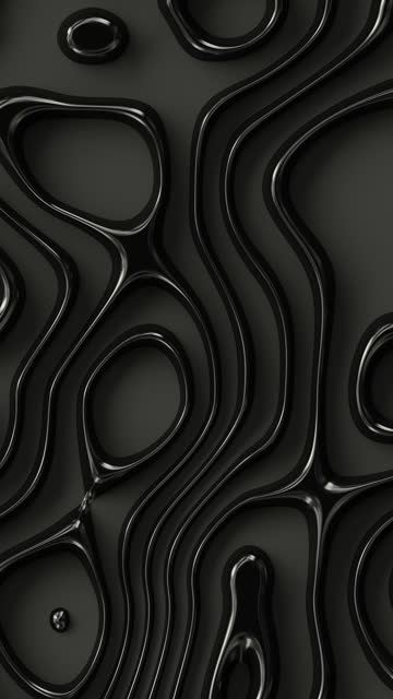Wavy abstract surface. Close-up of a shiny smooth black liquid.