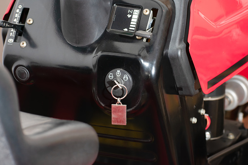 the essential role of a tractor's ignition key in starting up the machinery needed for efficient lawn mowing.