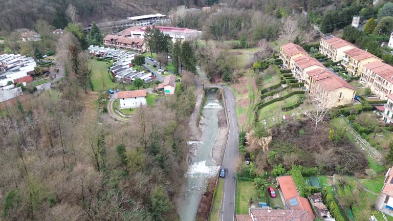 cinematic aerial view long the line of a natural river between mountain in cloudy weather