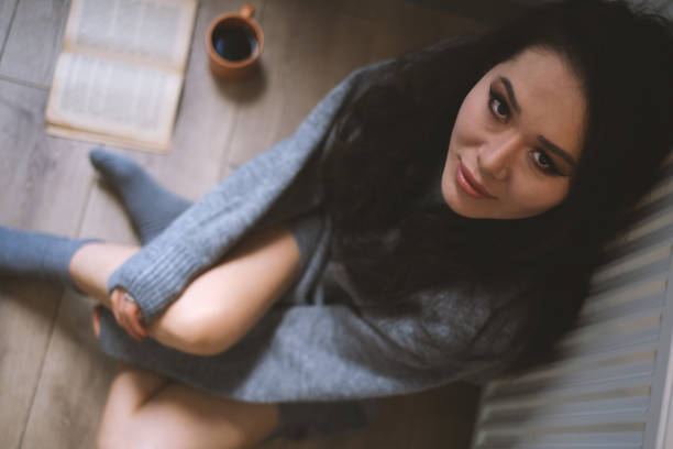 istock Young Woman Enjoying Her Coffee And Book 2071548137