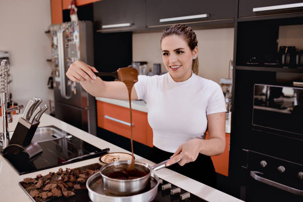 istock Woman making chocolate for easter at her kitchen 2071560660