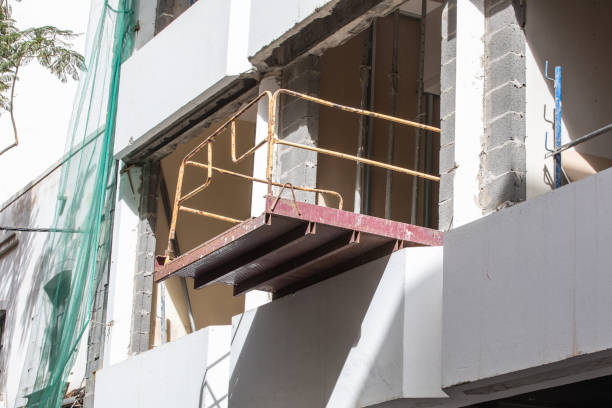 istock High rise building under construction - showing scaffolding and Acrow props securing the floors under build. 2071578262