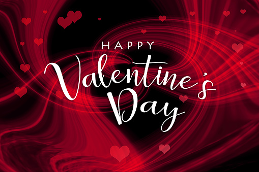 HAPPY VALENTINE'S DAY lettering on an abstract background made of glowing light trails forming a heart shape in the center with lots of small red hearts. Can be used as a design for Valentine's day holiday greeting cards or posters.