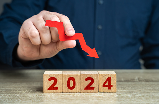 2024 and red arrow down. Forecast for an decrease next year. Fall in profits and orders, economic decline. Unfavorable investment conditions. Stagnation and recession. A crisis. Pessimistic forecast.
