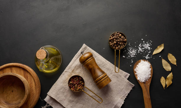 istock Salt, allspice, peppercorns and olive oil in a bottle on a black table 2071650030