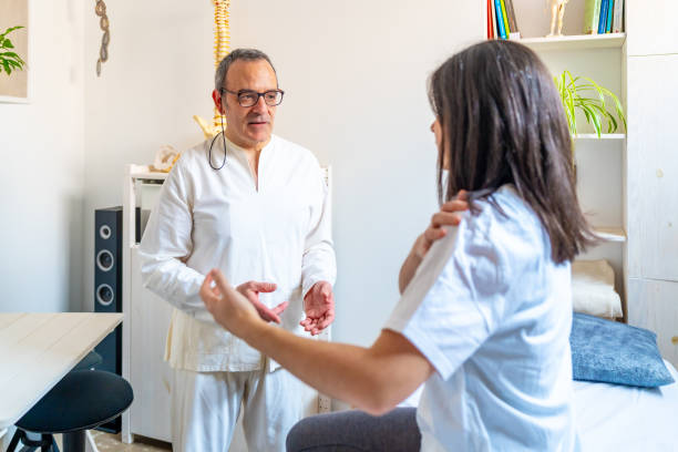 istock Qi gong therapist communicating with patient explaining her pain 2071652704
