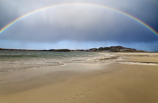 Rainbow across Reef Beach on the Isle of Lewis in the outer Hebrides Scotland in the Atlantic Ocean.