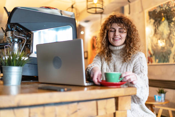 piękna kobieta pracująca na laptopie w kawiarni - caffeine caucasian satisfaction small business zdjęcia i obrazy z banku zdjęć