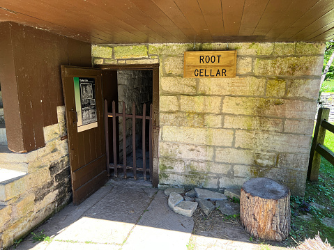 Mitchell, Indiana, USA - June 20, 2022:  Outside the Root Cellar in the recreated and restored 1800 Pioneer Village at Spring Mill State Park, near Mitchell, Indiana.