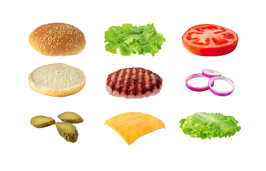Tasty colorful sandwich ingredients isolated on white. Hamburger with patty of ground beef meat, cheese, lettuce, tomato, onion, \npickles and bun with sesame seeds. Burger recipe concept.