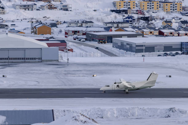 Airplane is landing on airport in winter.