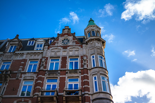 Explore the charm and architectural heritage of Amsterdam through its vibrant streets, where iconic buildings paint a picturesque cityscape.