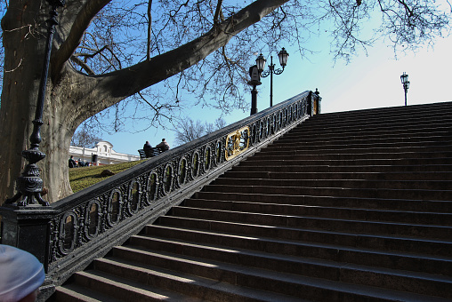 Beautiful staircase with wrought iron railings against the blue sky.