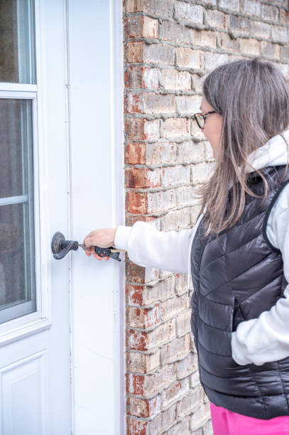 istock Mature woman opening outside door 2071927765