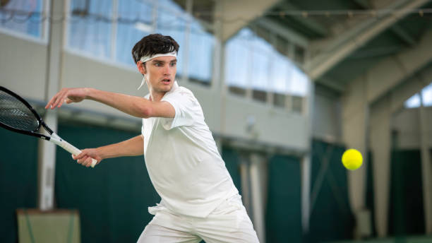 istock Male tennis player hitting ball with racket 2071934539