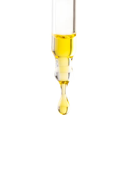 istock Pipette with yellow oil drop on the whte isolated background Close up.Copy space 2071935092