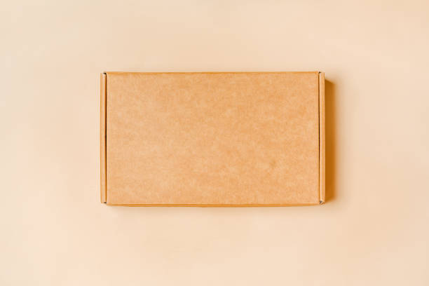 istock Eco-Friendly Packaging: Top View of Cardboard Box on Beige Background 2071937787
