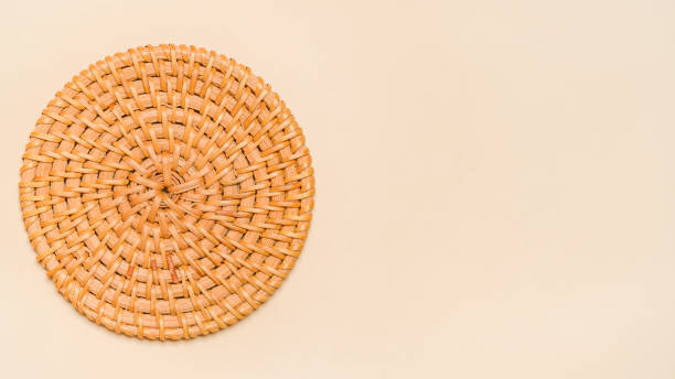 istock Wicker tray on beige background. Rattan weave circles. Beautiful brown rattan pattern background. Eco. Copy space 2071937791