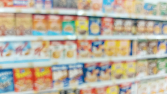 supermarket aisle and shelves blurred background. grocery store retail business concept