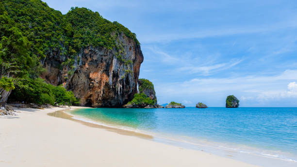istock a tropical beach with a large rock in the background 2071980977