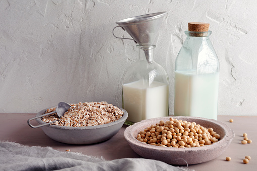 Soy and oat milk with soybeans and oat flakes