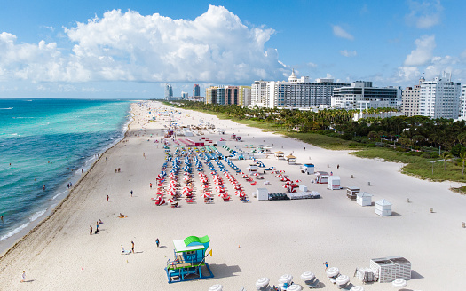 Drone aerial view at Miami South Beach Florida. Beach with colorful chairs and umbrellas, top view of the beach Miami Florida