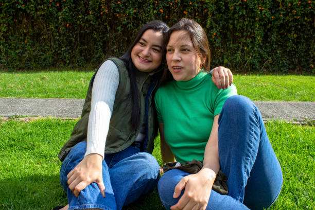 istock Two beautiful young women having fun in a public park 2072034411