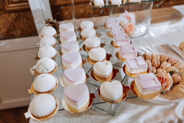 istock Festive dessert table with sweets. Wedding candy bar, various cakes, chocolates on stands. 2072064967