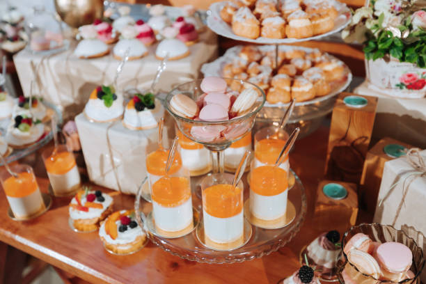 istock Festive dessert table with sweets. Wedding candy bar, various cakes, chocolates on stands. 2072069837