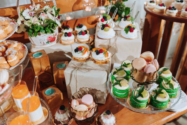 istock Festive dessert table with sweets. Wedding candy bar, various cakes, chocolates on stands. 2072069842
