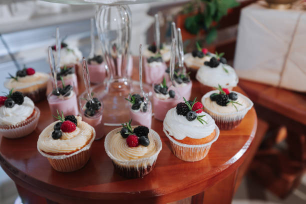 istock Festive dessert table with sweets. Wedding candy bar, various cakes, chocolates on stands. 2072069843